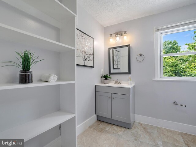 6202 K St, Capitol Heights, MD 20743 - bathroom with vanity, baseboards, and a textured ceiling
