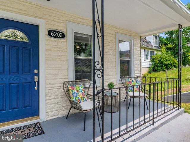 6202 K St, Capitol Heights, MD 20743 - doorway to property with covered porch and stone siding