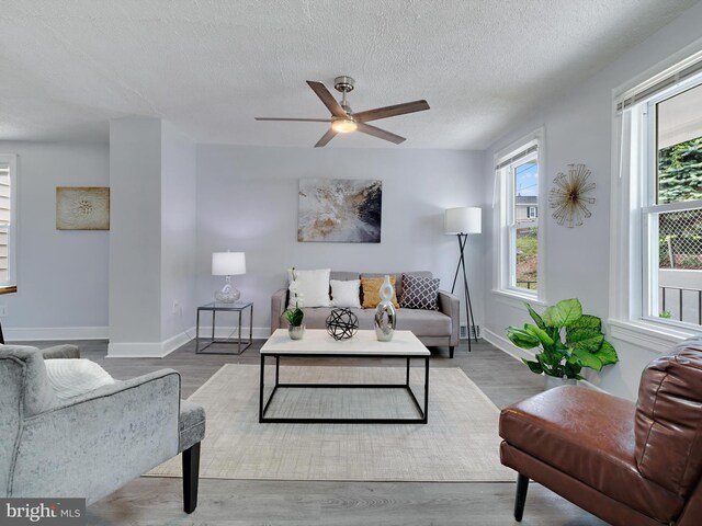 6202 K St, Capitol Heights, MD 20743 - living area with ceiling fan, a textured ceiling, baseboards, and wood finished floors