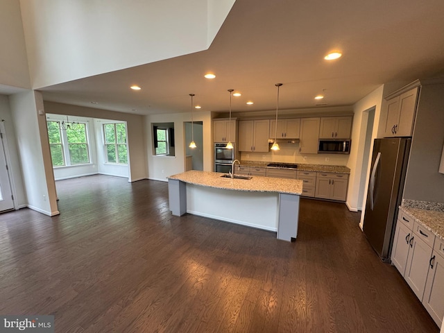 2410 Vineyard Springs Way, Ellicott City, MD 21043 - kitchen featuring stainless steel appliances, a sink, light stone countertops, dark wood-style flooring, and hanging light fixtures