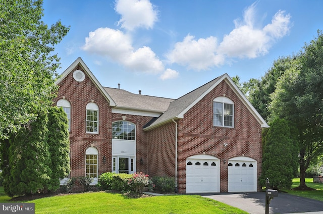 10861 Hunter Gate Way, Reston, VA 20194 - view of front of property with asphalt driveway, brick siding, a garage, and a front lawn