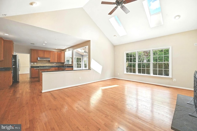 10861 Hunter Gate Way, Reston, VA 20194 - unfurnished living room with high vaulted ceiling, a ceiling fan, light wood-style flooring, a skylight, and recessed lighting