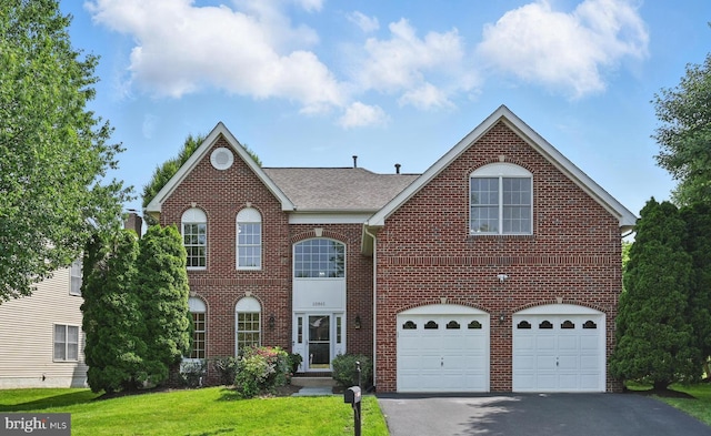 10861 Hunter Gate Way, Reston, VA 20194 - view of front of property featuring driveway, a garage, brick siding, a front lawn, and roof with shingles