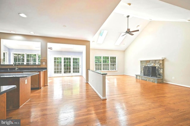 10861 Hunter Gate Way, Reston, VA 20194 - kitchen featuring dark countertops, brown cabinetry, a ceiling fan, open floor plan, and a skylight