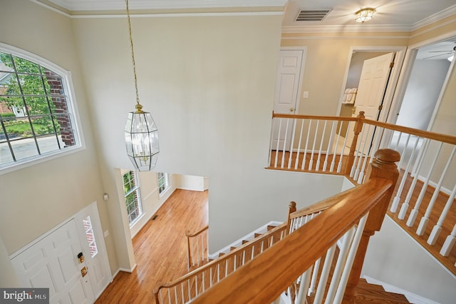 10861 Hunter Gate Way, Reston, VA 20194 - stairway featuring a chandelier, ornamental molding, wood finished floors, a high ceiling, and ceiling fan