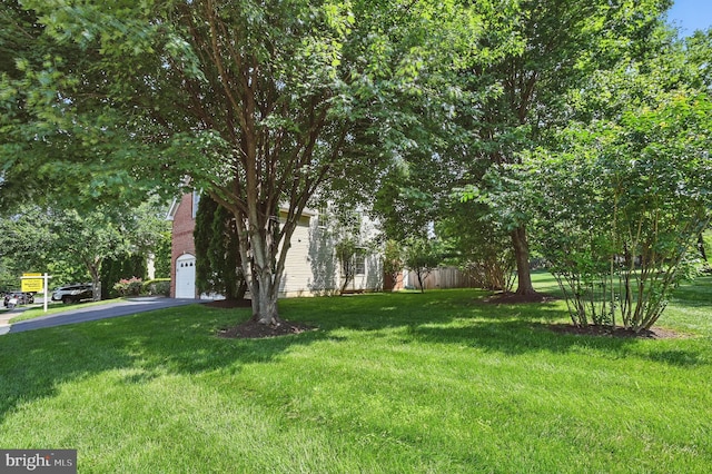 10861 Hunter Gate Way, Reston, VA 20194 - view of grassy yard with driveway and an attached garage