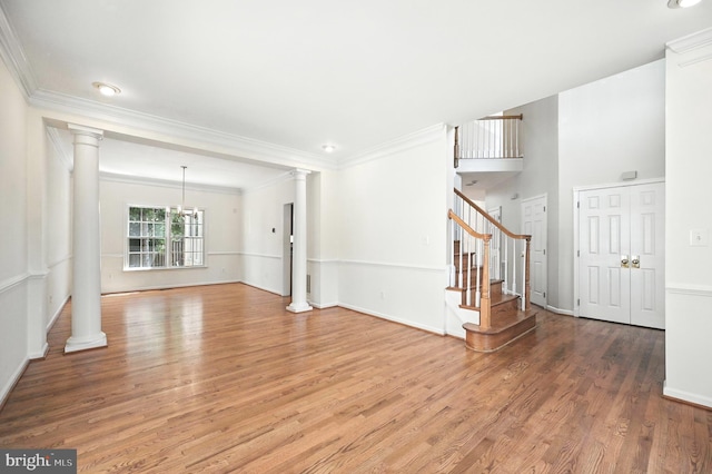 10861 Hunter Gate Way, Reston, VA 20194 - unfurnished living room featuring ornate columns, light wood-type flooring, crown molding, stairs, and a chandelier