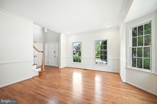 10861 Hunter Gate Way, Reston, VA 20194 - unfurnished living room with light wood-style floors, stairway, and crown molding