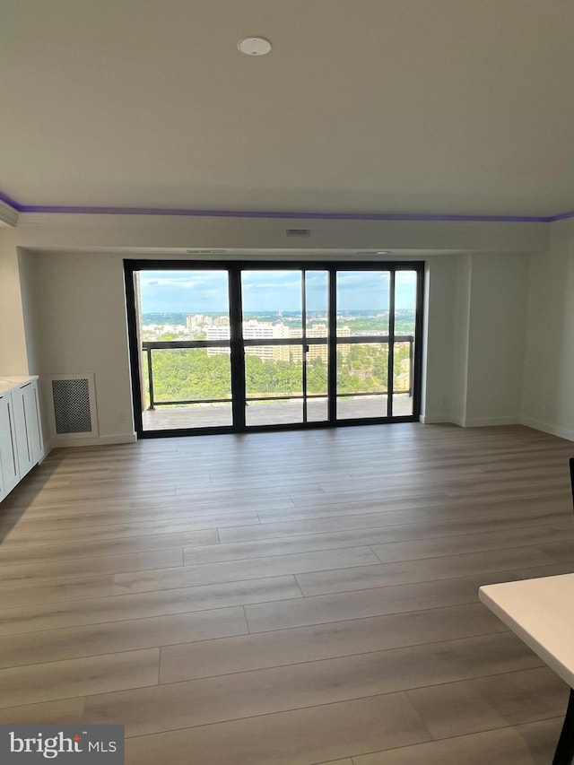307 Yoakum Pkwy Unit 1801, Alexandria, VA 22304 - unfurnished living room featuring light wood-type flooring and baseboards