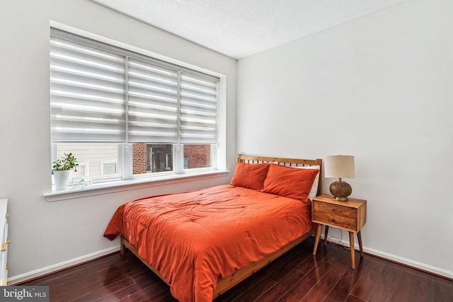 2630 Adams Mill Rd NW Unit 302, Washington, DC 20009 - bedroom featuring wood finished floors and baseboards