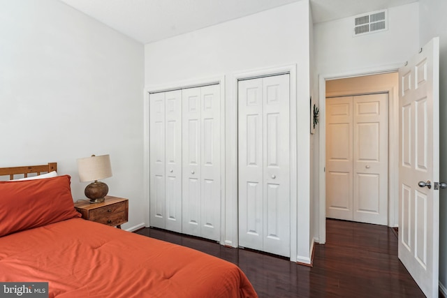 2630 Adams Mill Rd NW Unit 302, Washington, DC 20009 - bedroom featuring dark wood-style floors, multiple closets, and baseboards