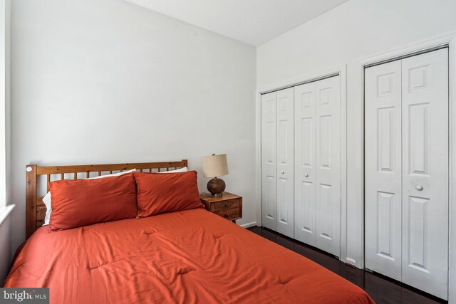2630 Adams Mill Rd NW Unit 302, Washington, DC 20009 - bedroom featuring multiple closets and dark wood-type flooring