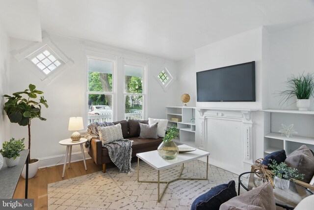405 Calvin Ave, Baltimore, MD 21218 - living room featuring healthy amount of natural light, wood finished floors, and baseboards