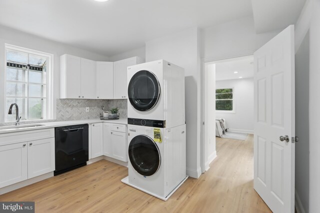 405 Calvin Ave, Baltimore, MD 21218 - washroom featuring stacked washer and clothes dryer, light wood-type flooring, and recessed lighting