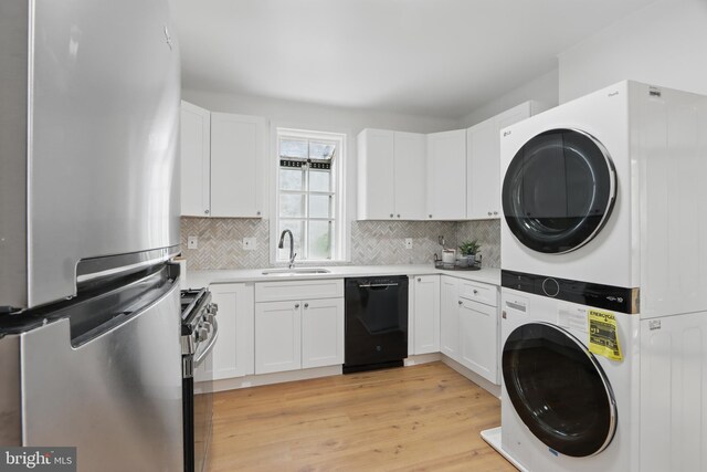 405 Calvin Ave, Baltimore, MD 21218 - laundry room with estacked washer and dryer and light wood finished floors