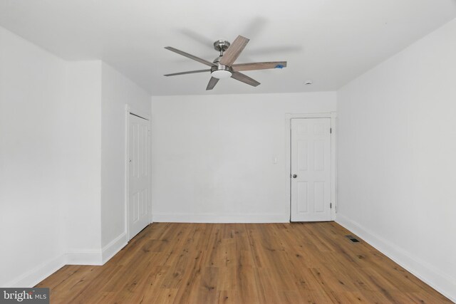 405 Calvin Ave, Baltimore, MD 21218 - empty room with ceiling fan, wood finished floors, and baseboards