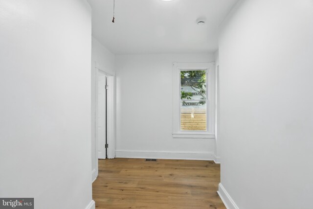 405 Calvin Ave, Baltimore, MD 21218 - empty room featuring wood finished floors, baseboards, and a smoke detector