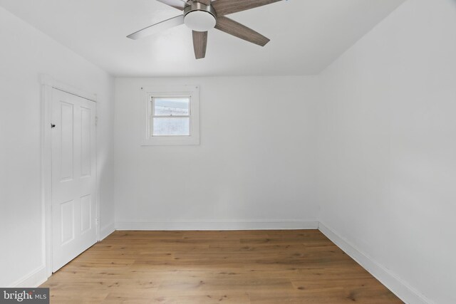 405 Calvin Ave, Baltimore, MD 21218 - unfurnished bedroom with baseboards, light wood-style floors, and a ceiling fan