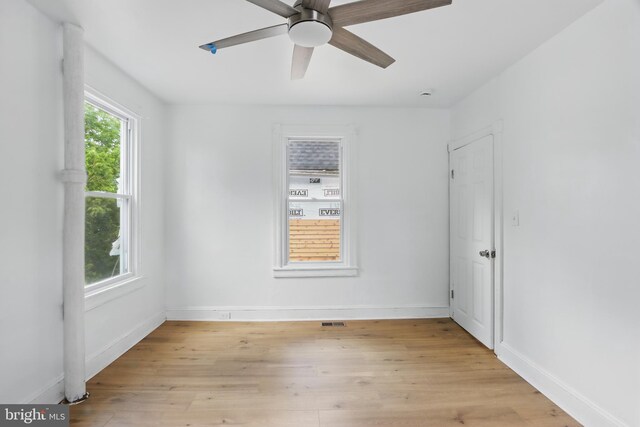 405 Calvin Ave, Baltimore, MD 21218 - empty room featuring light wood finished floors, baseboards, and a ceiling fan