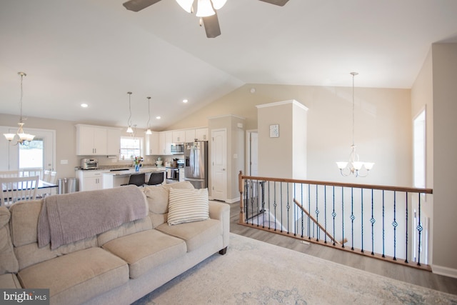 316 Pochards Ct, Martinsburg, WV 25403 - living area featuring a chandelier, light wood-style floors, vaulted ceiling, a ceiling fan, and recessed lighting