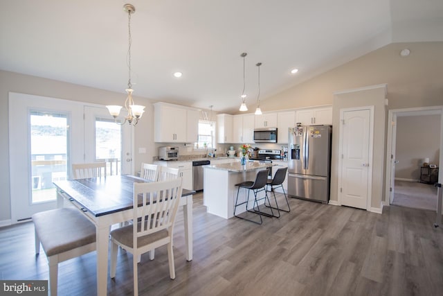 316 Pochards Ct, Martinsburg, WV 25403 - dining space with lofted ceiling, a chandelier, wood finished floors, and recessed lighting