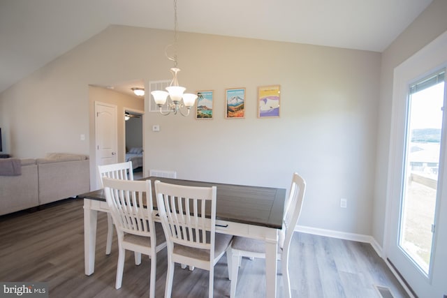 316 Pochards Ct, Martinsburg, WV 25403 - dining room with a chandelier, wood finished floors, vaulted ceiling, and baseboards
