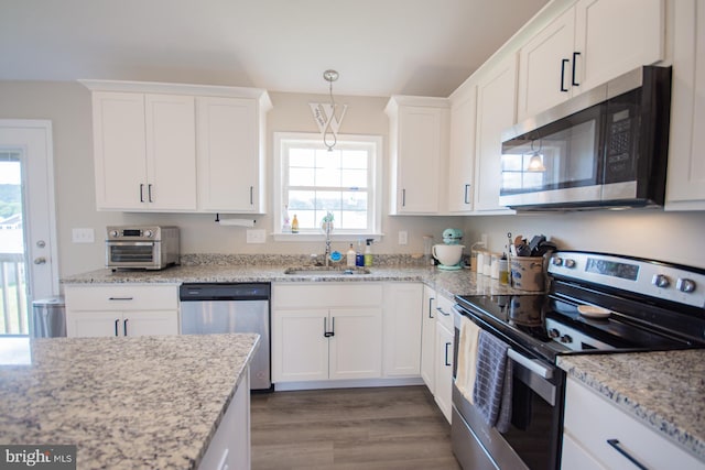 316 Pochards Ct, Martinsburg, WV 25403 - kitchen featuring stainless steel appliances, a sink, white cabinetry, and wood finished floors
