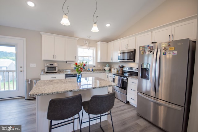 316 Pochards Ct, Martinsburg, WV 25403 - kitchen featuring appliances with stainless steel finishes, a center island, white cabinets, lofted ceiling, and wood finished floors