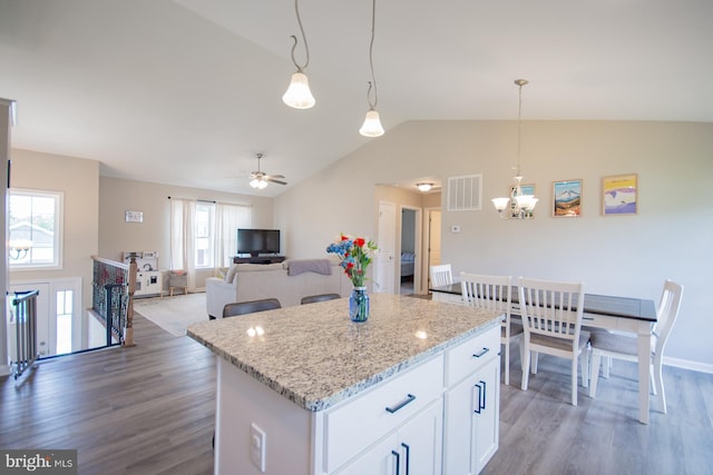 316 Pochards Ct, Martinsburg, WV 25403 - kitchen featuring lofted ceiling, wood finished floors, a chandelier, a kitchen island, and light stone counters