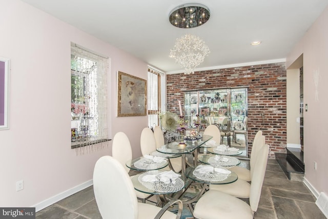 2500 Edge Hill Rd, Huntingdon Valley, PA 19006 - dining room featuring baseboards, a chandelier, brick wall, and stone finish floors