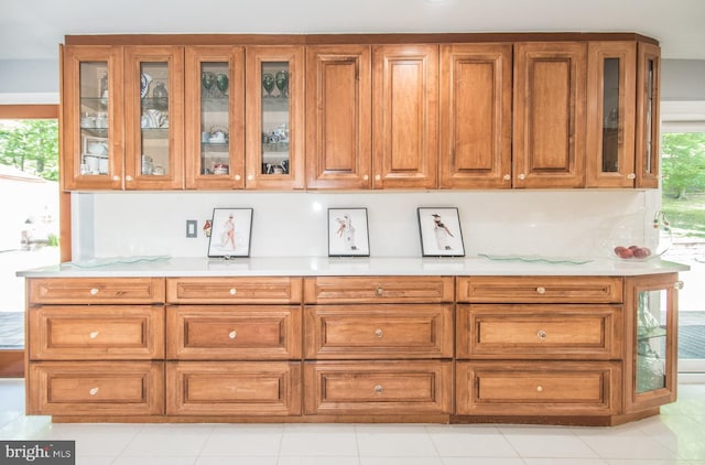2500 Edge Hill Rd, Huntingdon Valley, PA 19006 - kitchen featuring brown cabinetry, light countertops, and glass insert cabinets