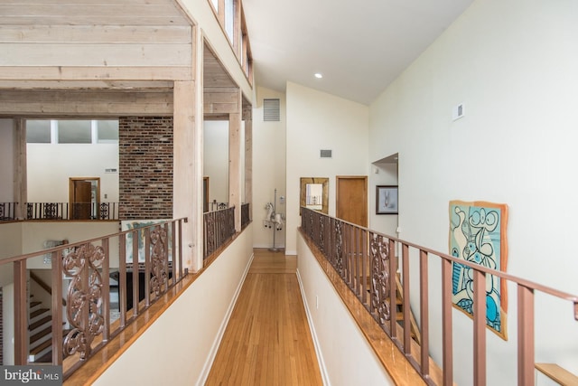 2500 Edge Hill Rd, Huntingdon Valley, PA 19006 - hallway featuring wood finished floors, baseboards, an upstairs landing, and high vaulted ceiling