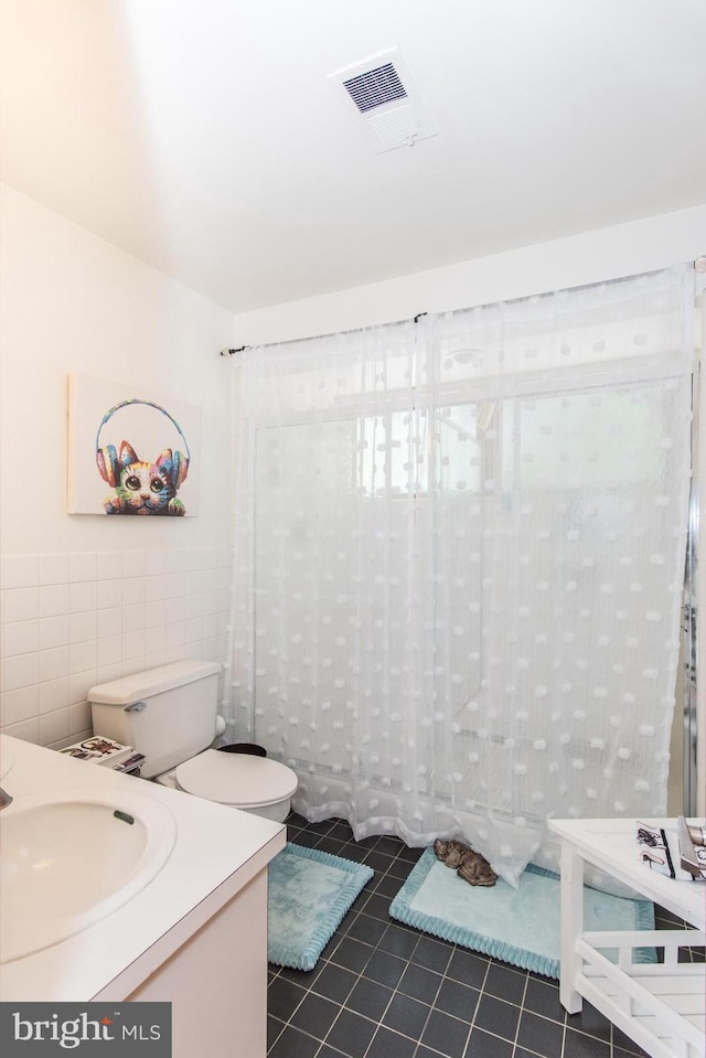 2500 Edge Hill Rd, Huntingdon Valley, PA 19006 - full bathroom featuring tile walls, tile patterned flooring, vanity, and toilet