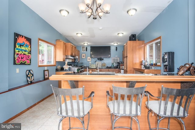 2500 Edge Hill Rd, Huntingdon Valley, PA 19006 - kitchen with wall chimney exhaust hood, a chandelier, and light tile patterned flooring