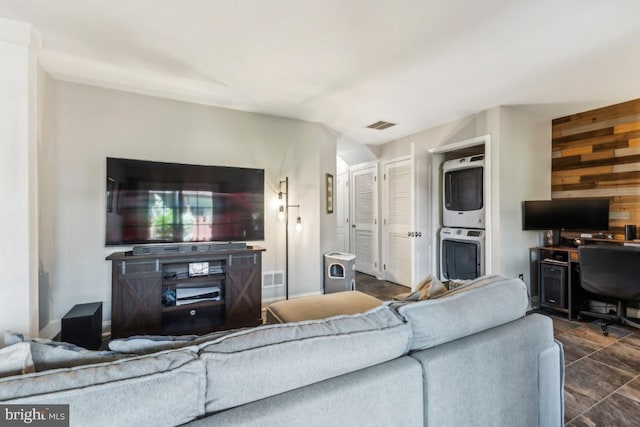 13512 Turquoise Ln, Herndon, VA 20170 - living area with estacked washer and dryer, wooden walls, an office area, and dark tile patterned floors