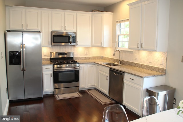 13512 Turquoise Ln, Herndon, VA 20170 - kitchen with appliances with stainless steel finishes, a sink, white cabinets, dark wood-style flooring, and light stone counters
