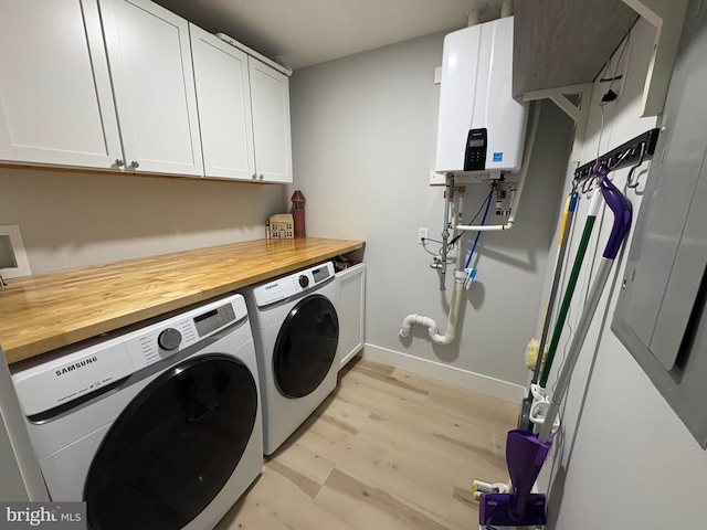 4112 Park Blvd Unit G, Wildwood, NJ 08260 - laundry area featuring cabinet space, water heater, washer and clothes dryer, light wood finished floors, and baseboards