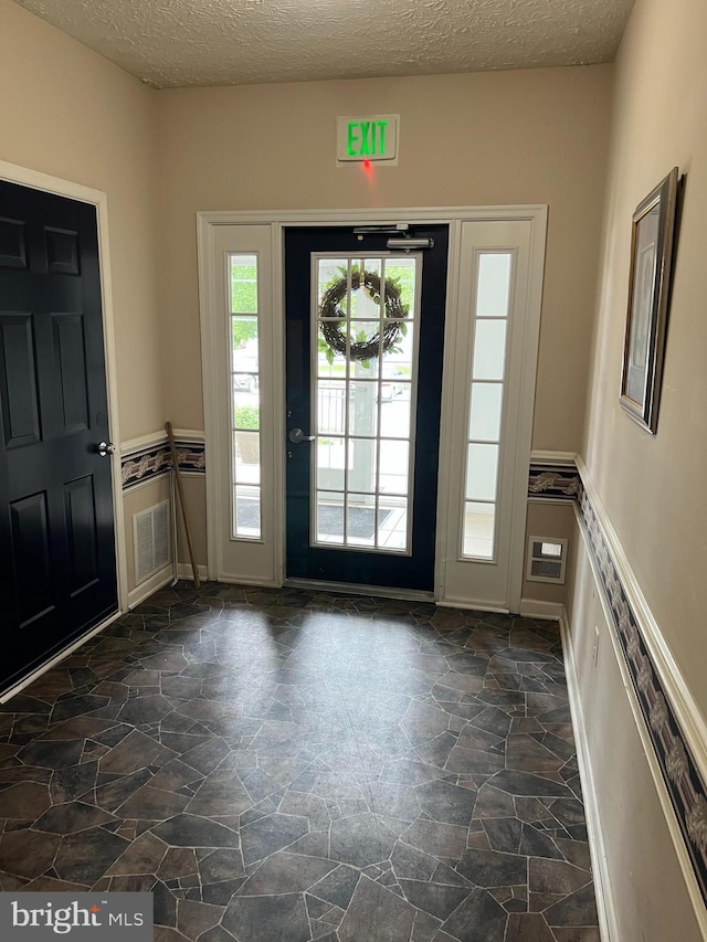 5236 Millfield Rd Unit 5236, Baltimore, MD 21237 - foyer entrance with dark stone finish floors and a textured ceiling