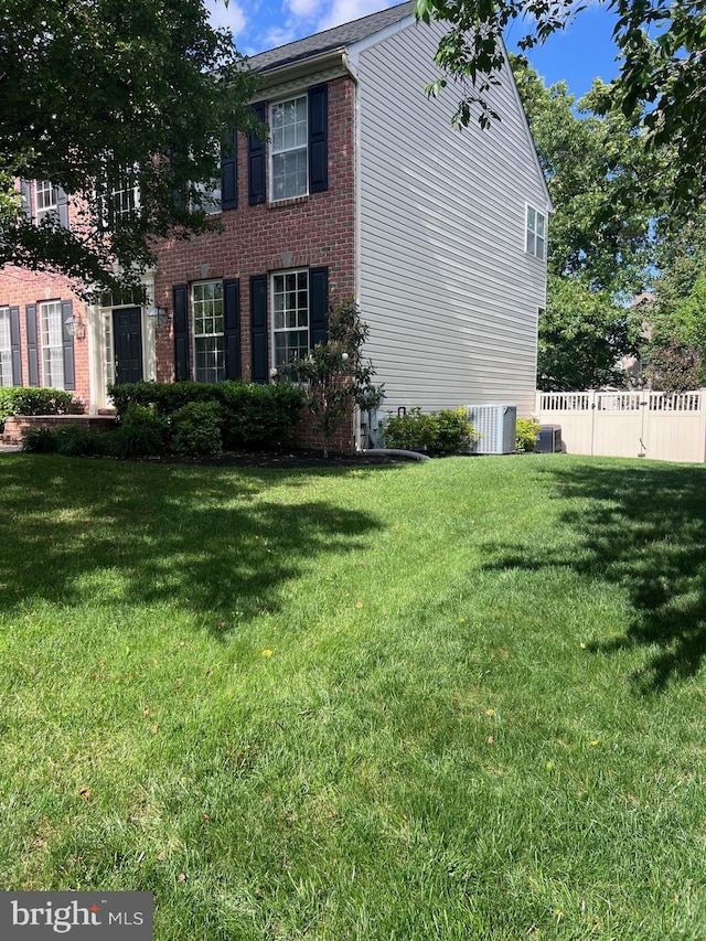 8242 Green Ice Dr, Pasadena, MD 21122 - view of property exterior with brick siding and central AC