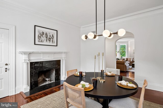 3 Devon Hill Rd Unit D4, Baltimore, MD 21210 - dining space featuring ornamental molding, arched walkways, wood finished floors, and a fireplace