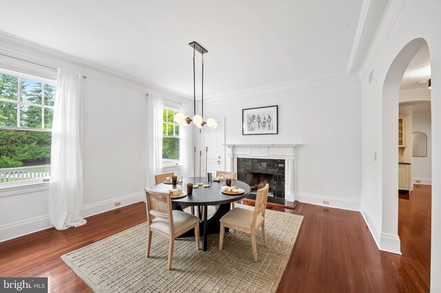3 Devon Hill Rd Unit D4, Baltimore, MD 21210 - dining room with crown molding, arched walkways, a fireplace, baseboards, and wood finished floors