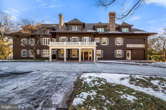 3 Devon Hill Rd Unit D4, Baltimore, MD 21210 - snow covered house with a chimney, a balcony, and covered porch