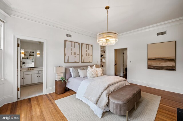 3 Devon Hill Rd Unit D4, Baltimore, MD 21210 - bedroom with a chandelier, ornamental molding, light wood-type flooring, a sink, and baseboards