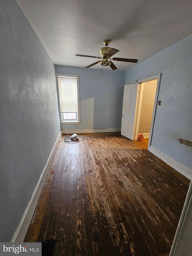 5541 Race St, Philadelphia, PA 19139 - unfurnished bedroom with wood-type flooring, baseboards, and a ceiling fan