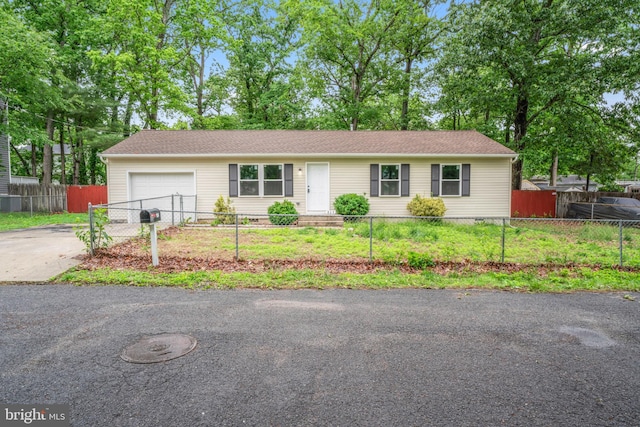 156 Dennis Ave, Browns Mills, NJ 08015 - ranch-style home featuring an attached garage, a fenced front yard, and concrete driveway