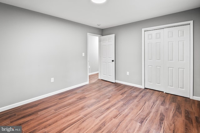 156 Dennis Ave, Browns Mills, NJ 08015 - unfurnished bedroom featuring baseboards, wood finished floors, and a closet