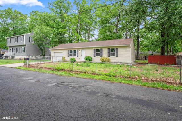 156 Dennis Ave, Browns Mills, NJ 08015 - view of front of home featuring a garage, a fenced front yard, and asphalt driveway