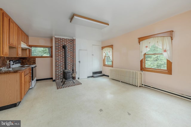 77 Alloway Friesburg Rd, Alloway, NJ 08001 - kitchen featuring range with electric stovetop, radiator, under cabinet range hood, a wood stove, and light floors