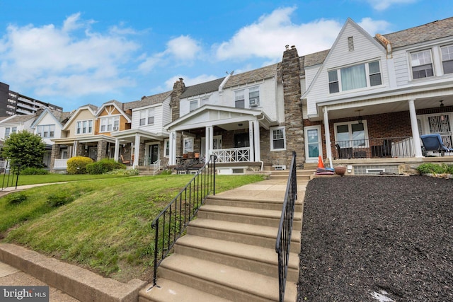 4441 Sherwood Rd, Philadelphia, PA 19131 - multi unit property featuring a porch, a residential view, a front lawn, a chimney, and stone siding
