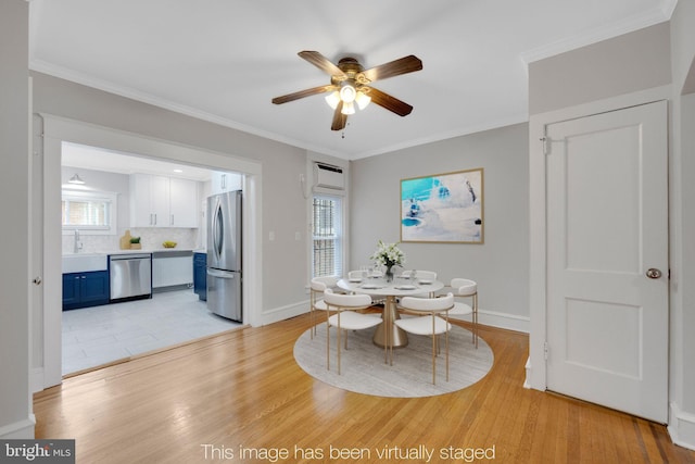 4441 Sherwood Rd, Philadelphia, PA 19131 - dining room featuring a ceiling fan, light wood finished floors, ornamental molding, and baseboards